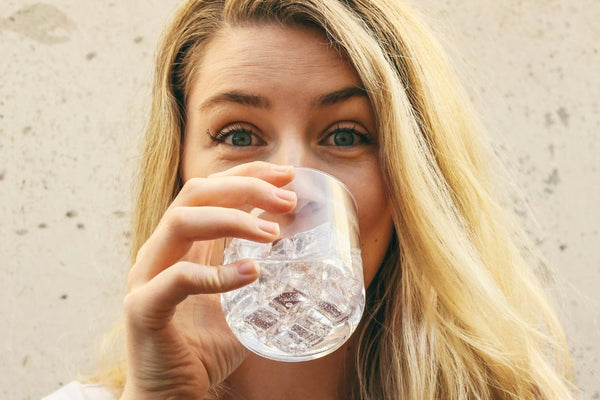 woman drinking water from a glass