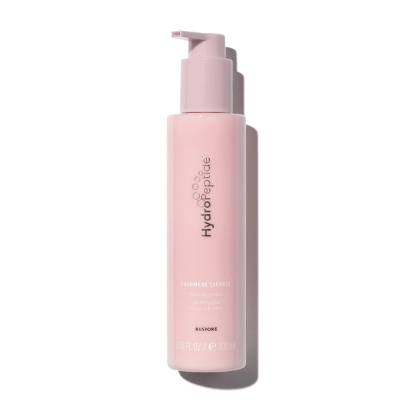 Pink bottle with pump dispenser on a white background