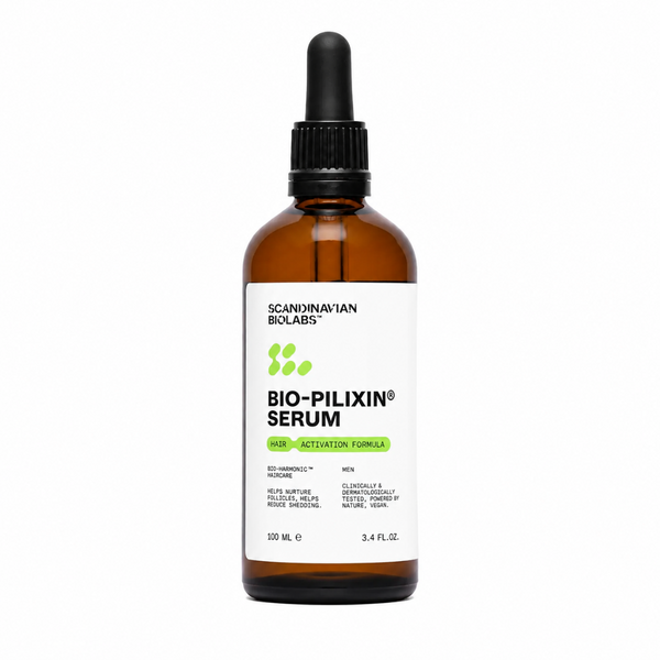 A 100 mL amber glass dropper bottle of Scandinavian Biologs Bio-Pilixin Serum for men, featuring a white label with green and black text, and a black dropper cap, set against a plain white background.