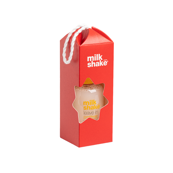 A red milkshake carton-style packaging box with a white rope handle and a star-shaped clear window showing a light beige drink inside. The box has the words 'milk shake' printed in white near the top and 'milk shake leave n' in yellow/orange on the window area.