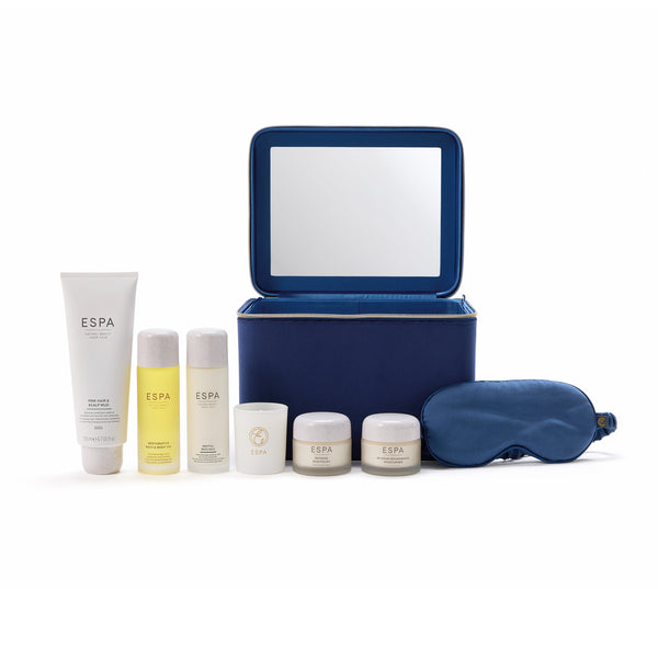 ESPĀ® skincare set with blue travel case and eye mask on a white background