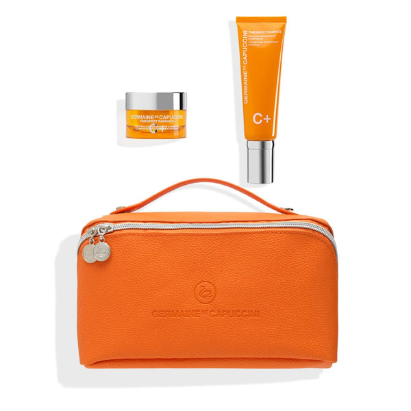Orange cosmetic bag with skincare products on a white background