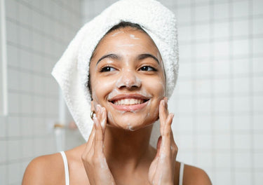 Smiling lady washing her face