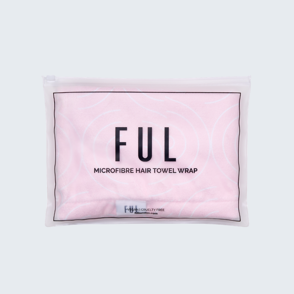 A light pink microfibre hair towel wrap inside a clear zippered plastic packaging sleeve, featuring the brand name 'FUL' in bold black letters.