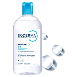 A 300 ml bottle of BIODERMA Hydrabio H2O micellar water, featuring a clear bottle with a bright blue cap and a white label, set against a white background with floating water droplets.