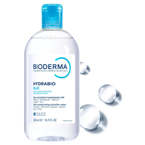 A 300 ml bottle of BIODERMA Hydrabio H2O micellar water, featuring a clear bottle with a bright blue cap and a white label, set against a white background with floating water droplets.