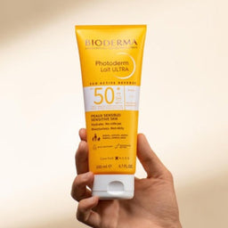 Model holding Bioderma Photoderm Lait ULTRA SPF 50+ for Sensitive Skin