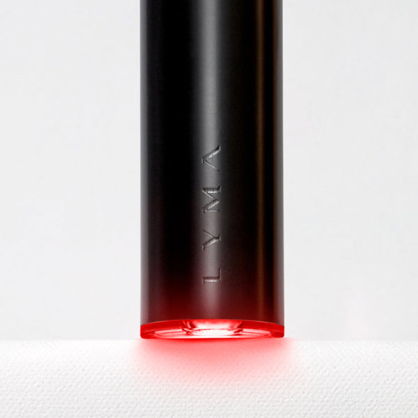 Black cylindrical device with red light on a white background