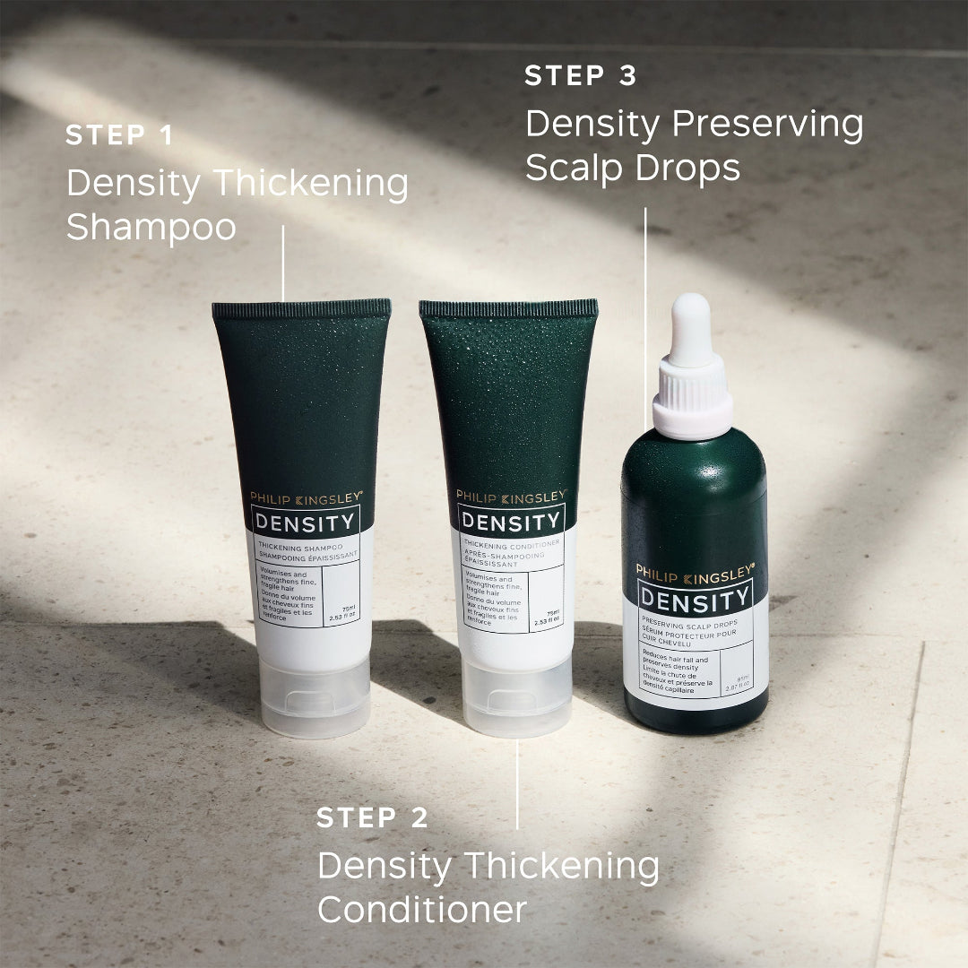 Three bottles of Philip Kingsley Density hair care products on a textured surface with step-by-step instructions.