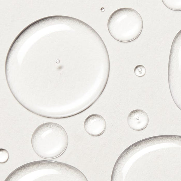 Close-up of clear bubbles on a light gray background