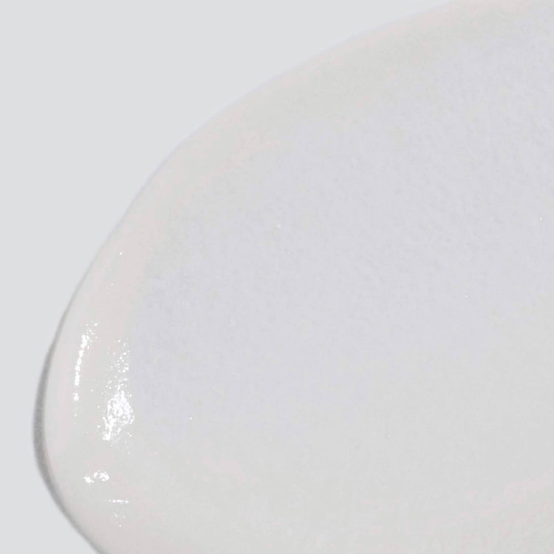 Close-up of a white ceramic plate on a white background