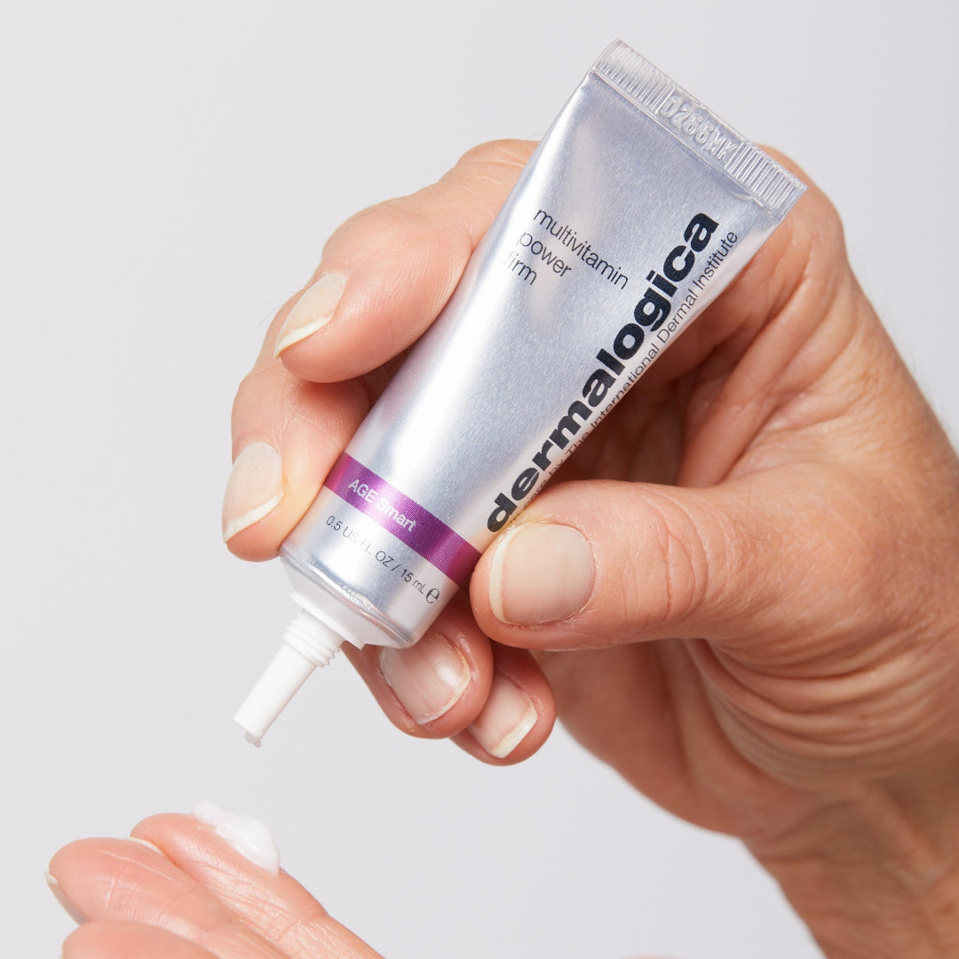 Hand holding a Dermalogica product with a white background