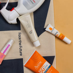 Various skincare products on a branded bag with 'Face the Future' text.
