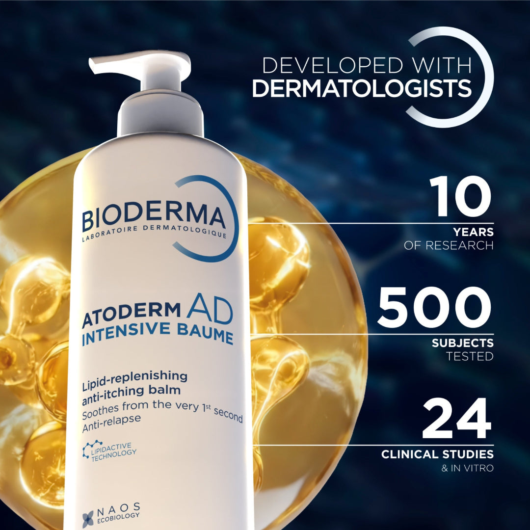 Bioderma Atoderm AD Intensive Balm pump bottle shown prominently on a dark blue background with gold ampoules and marketing text reading 'Developed with dermatologists,' '10 years of research,' '500 subjects tested,' and '24 clinical studies & in vitro.'.