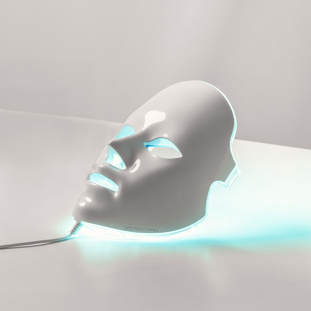 White LED face mask with blue light on a gray background