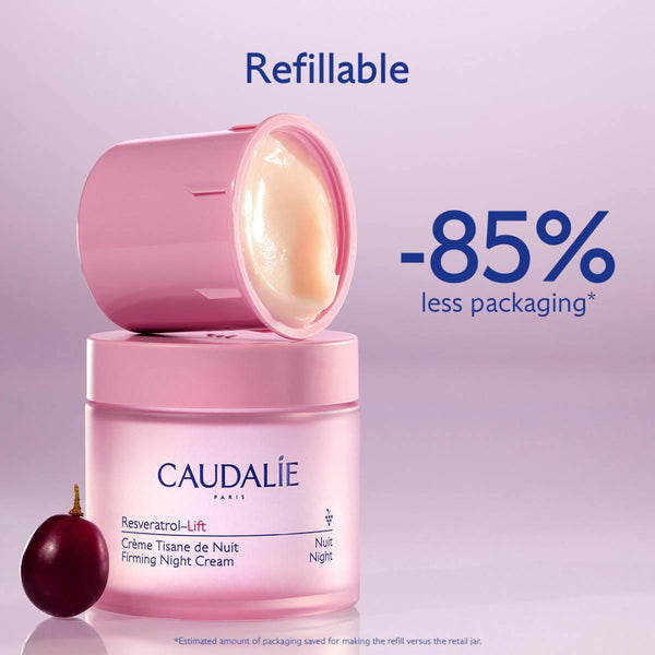 Caudalie Revveratrol-Lift Firming Night Cream refillable jar in pink, with the lid removed to show the cream inside, accompanied by a dark red onion and promotional text on a light purple background.