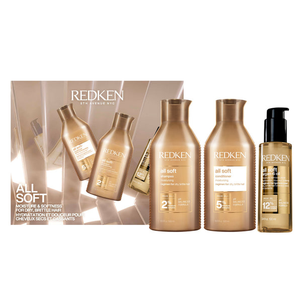 Redken Professionals All Soft haircare set featuring a shampoo bottle, a conditioner bottle, a leave-in conditioner pump bottle, and a matching retail box on a white background.