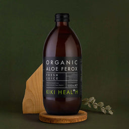 Bottle of Organic Aloe Ferox juice from Kiki Health on a dark green background