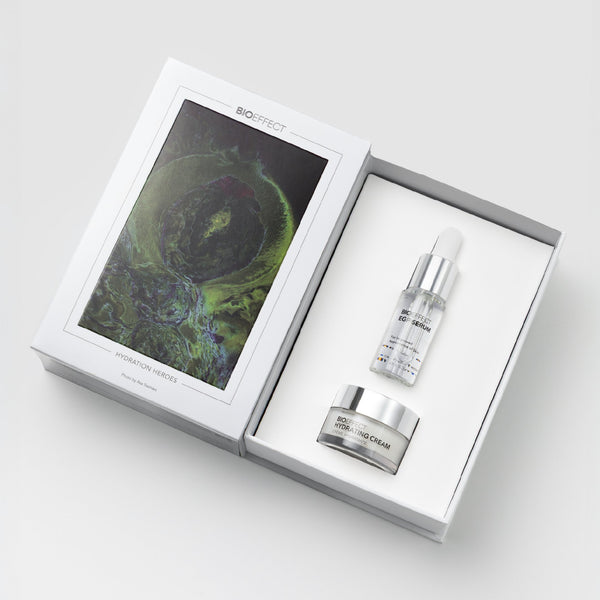 Cosmetic set with cream and serum in a white box on a light gray background