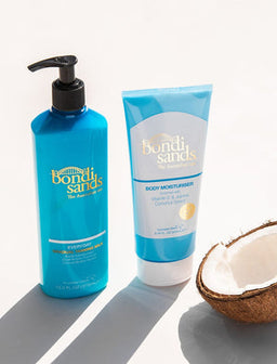 Bondi Sands Gradual Tanning Milk bottle next to a coconut half