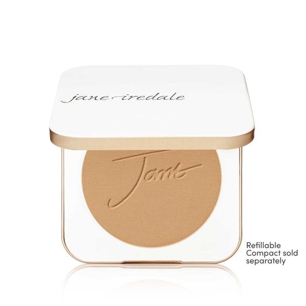 A Jane Iredale Tonto powder compact shown open on a white background, revealing a warm tan pressed powder pan with the Jane Iredale logo embossed. The compact has a white lid with gold trim and a small note in the lower right that reads 'Refillable Compact sold separately'.