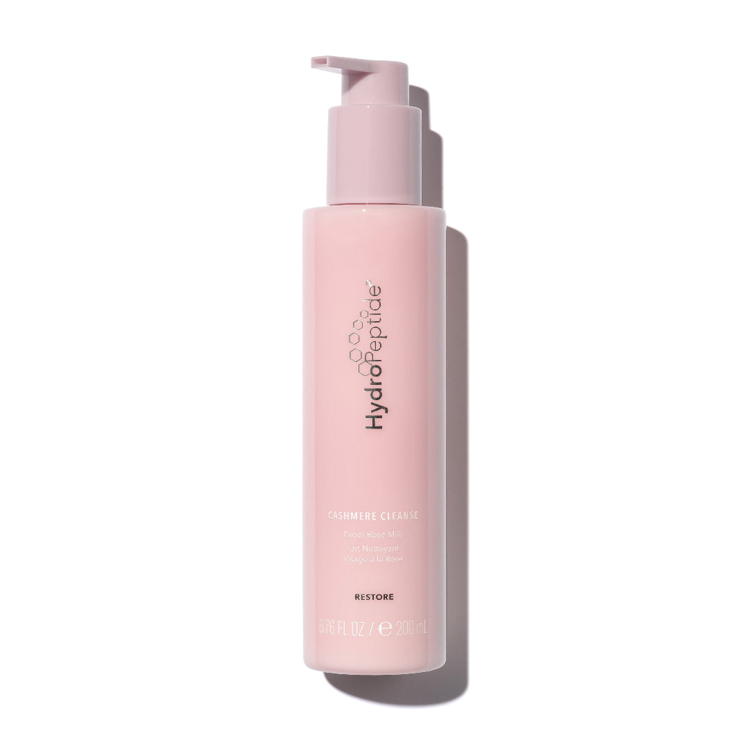 Pink bottle with pump dispenser on a white background