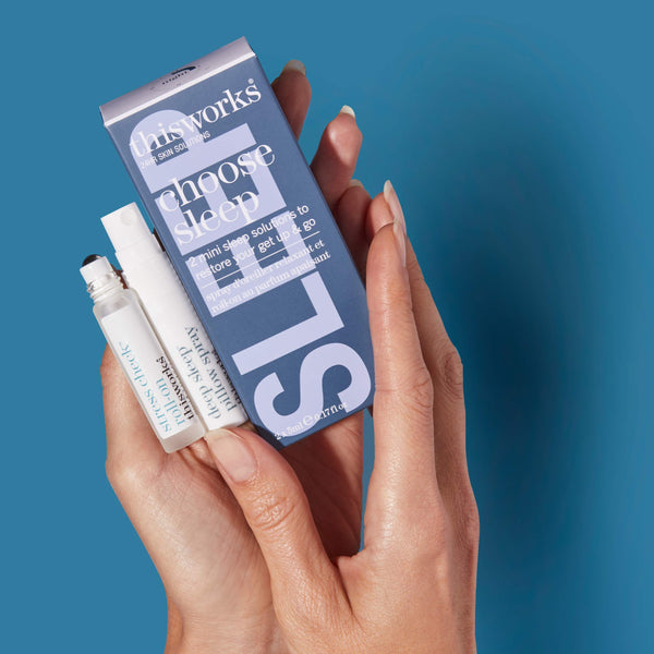Hand holding a 'Sleep Works' product against a blue background