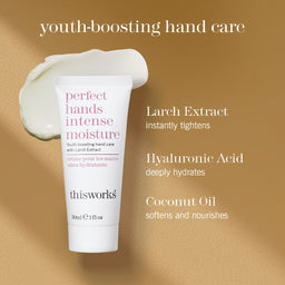 A white tube of thisworks 'perfect hands intense moisture' hand cream is shown on a warm beige textured background with a dollop of the cream above it. Text on the image highlights key ingredients: Larch Extract, Hyaluronic Acid, and Coconut Oil.