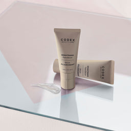 two Codex Labs Antu Brightening Serum tubes on a glass slate