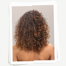 Curly hair from behind on a plain background