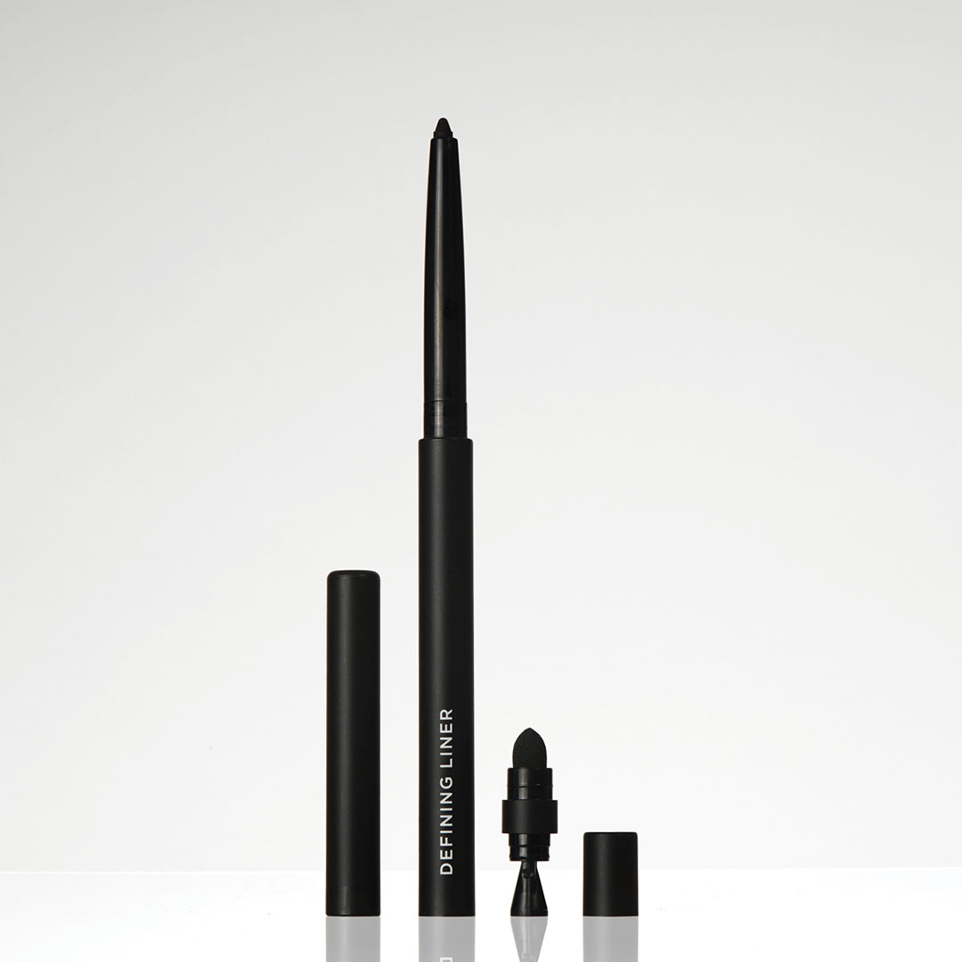 Black eyeliner pen with cap on a light gray background