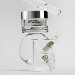 Germaine de Capuccini skincare products on a gray background