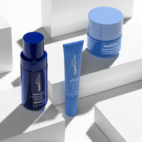 Blue skincare products on a white geometric background