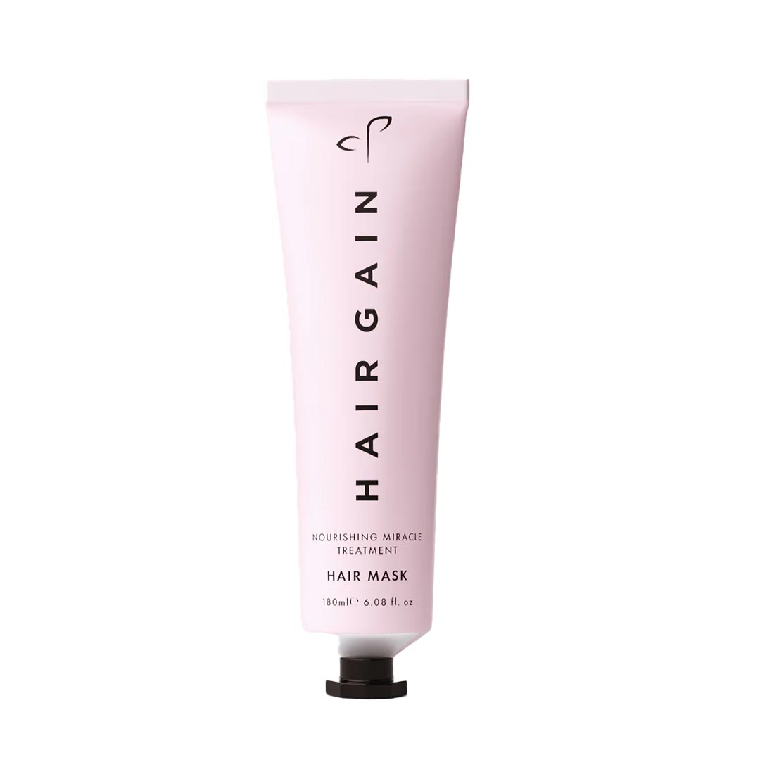 Pink tube of HairGain hair mask on a white background