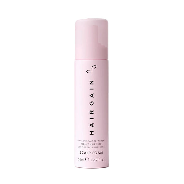 Pink bottle of HairGain scalp foam on a white background