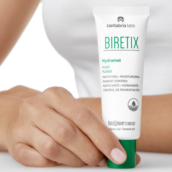 Tube of Biretix Hydramat cream held by a person with a white background