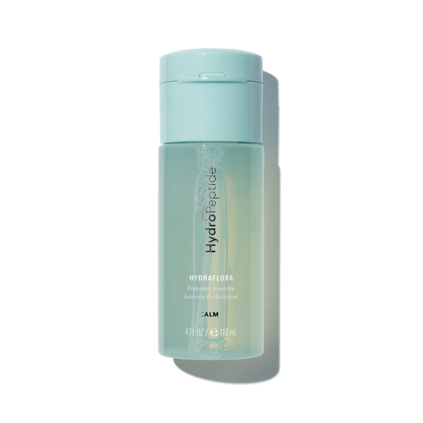 Skincare bottle with light blue cap and green body on a white background