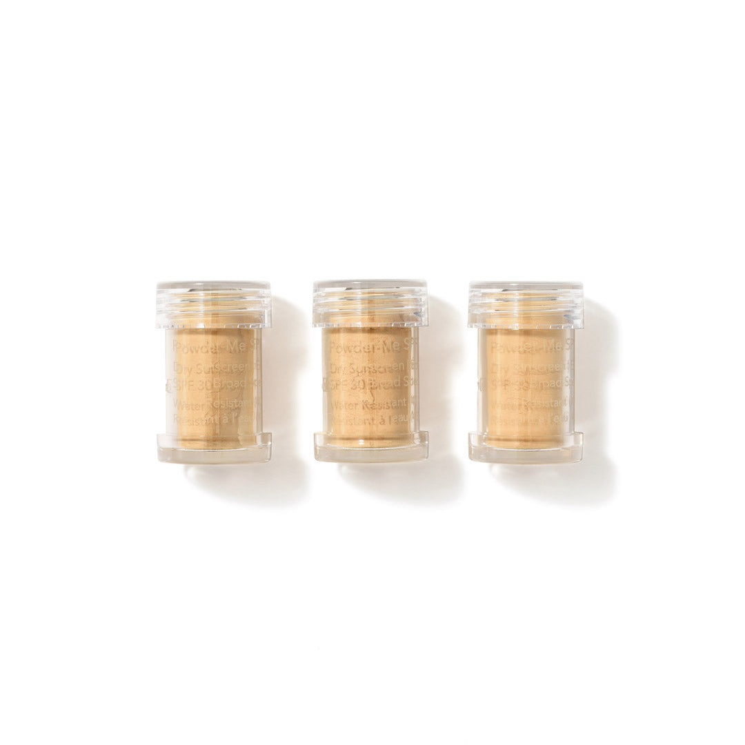 Three clear containers with gold contents on a white background