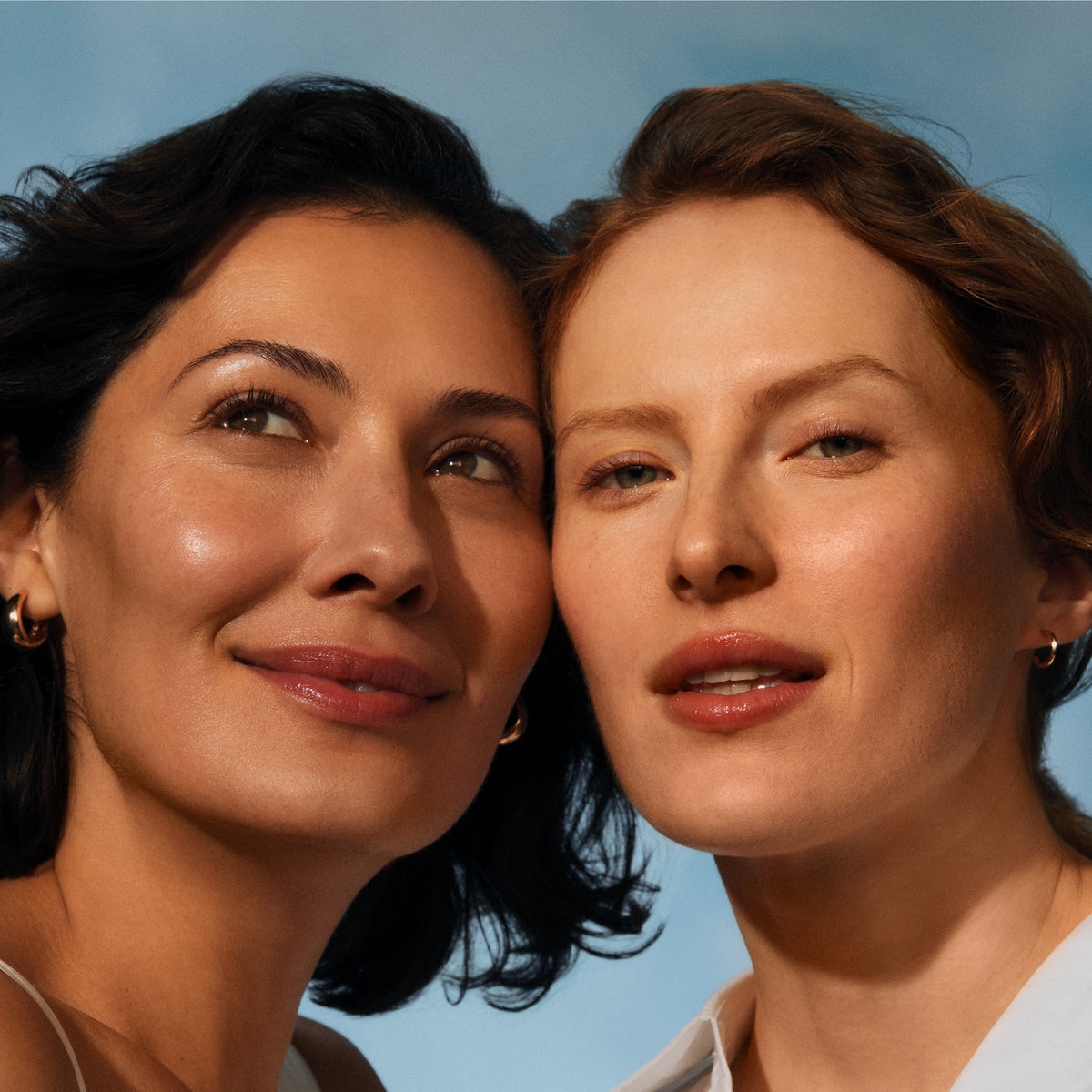 Two women with a clear blue sky background