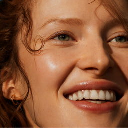 Close-up of a woman's face with a warm, sunlit glow.