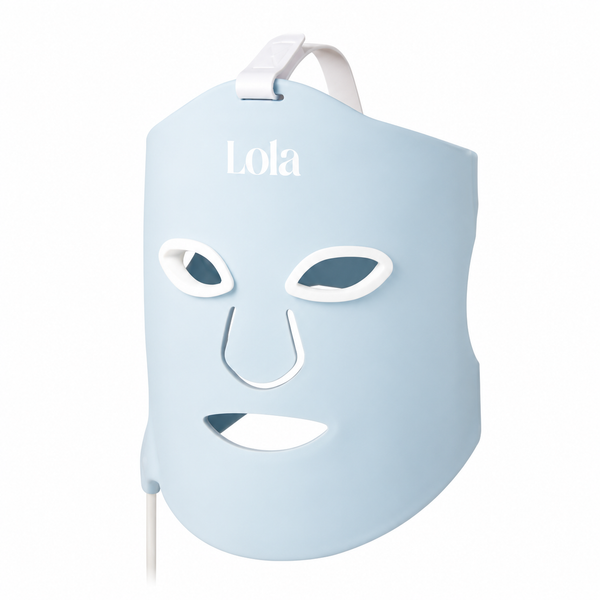 A light blue LED facial mask with white trim and straps, featuring the brand name 'Lola' printed in white on the forehead, shown against a plain white background.
