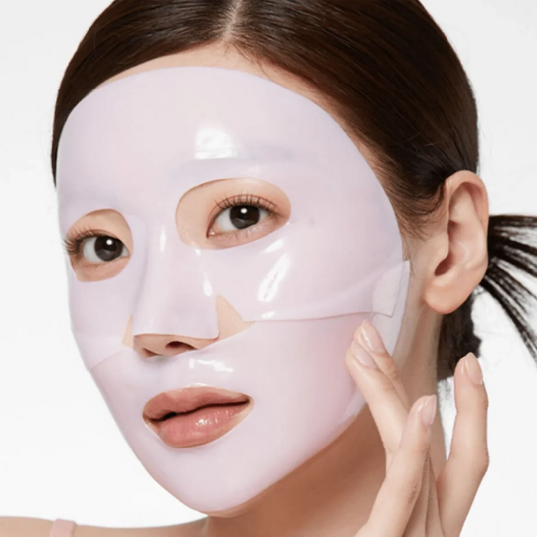 Woman wearing a white face mask on a plain background