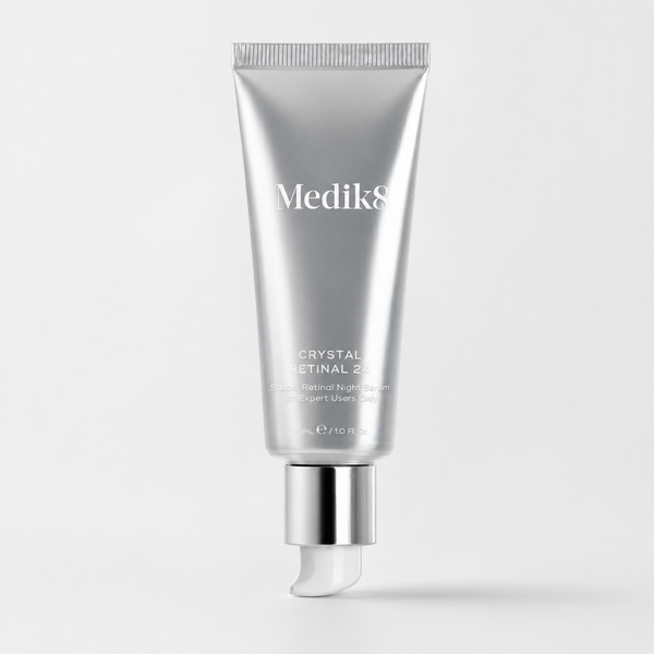 A silver squeeze tube of Medik8 Crystal Retinal 293 Retinol Night Cream with a metallic silver cap and a white pipette tip, centered on a light gray background.
