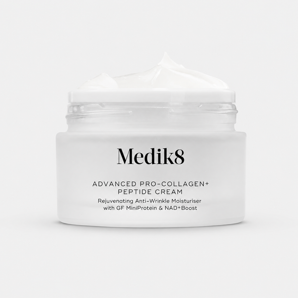 A white cosmetic jar of Medik8 Advanced Pro-Collagen+ Peptide Cream with a dollop of cream on top, set against a clean white background.