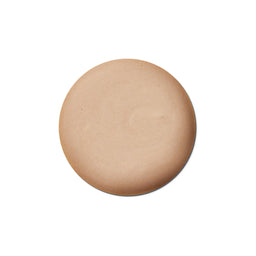Round beige makeup compact on a white background