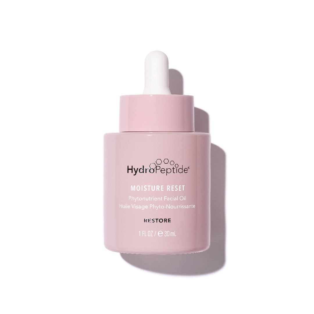 Pink skincare bottle with white cap on a light pink background