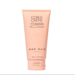 A tube of NAK HAIR Curls Creme hair product in a soft peach-pink color, centered on a plain white background.