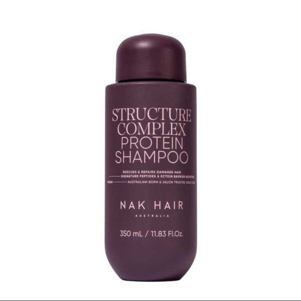 A bottle of NAK HAIR Structure Complex Protein Shampoo in a deep plum purple color, shown against a plain white background.