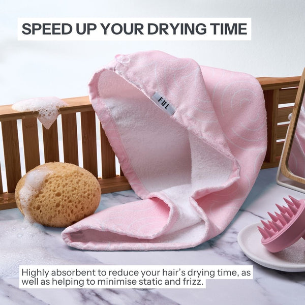 Pink hair drying cap on a marble surface with text about reducing drying time and minimizing static.
