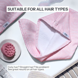 Pink hair accessory with white interior on a white surface, suitable for all hair types.